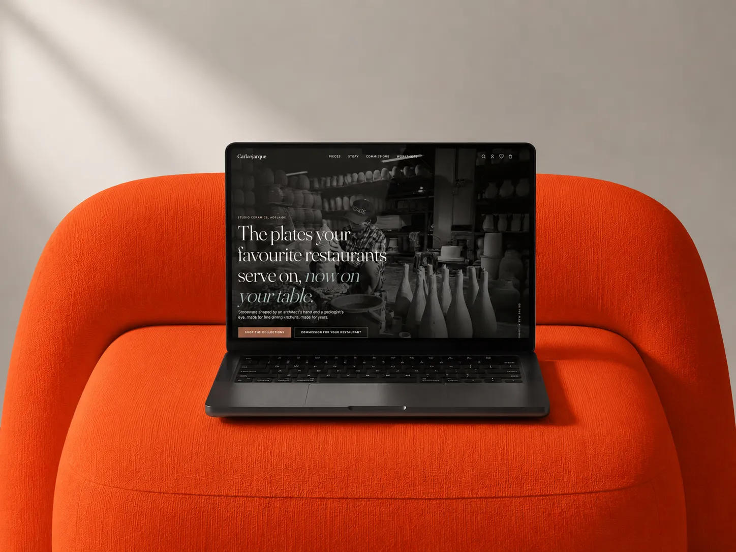 Carlaejarque Ceramics storefront shown on a laptop on an orange chair