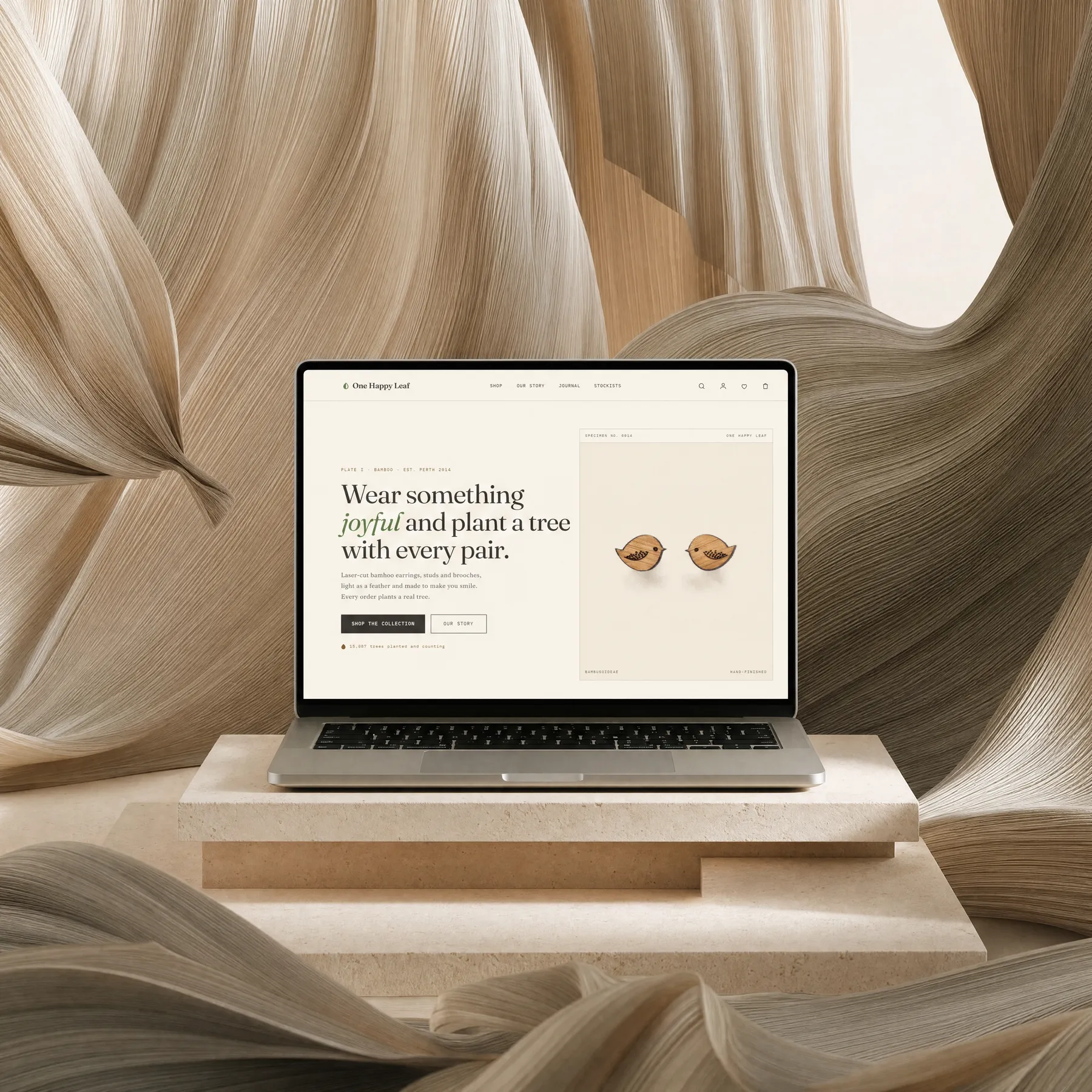 One Happy Leaf storefront shown on a laptop against flowing fabric